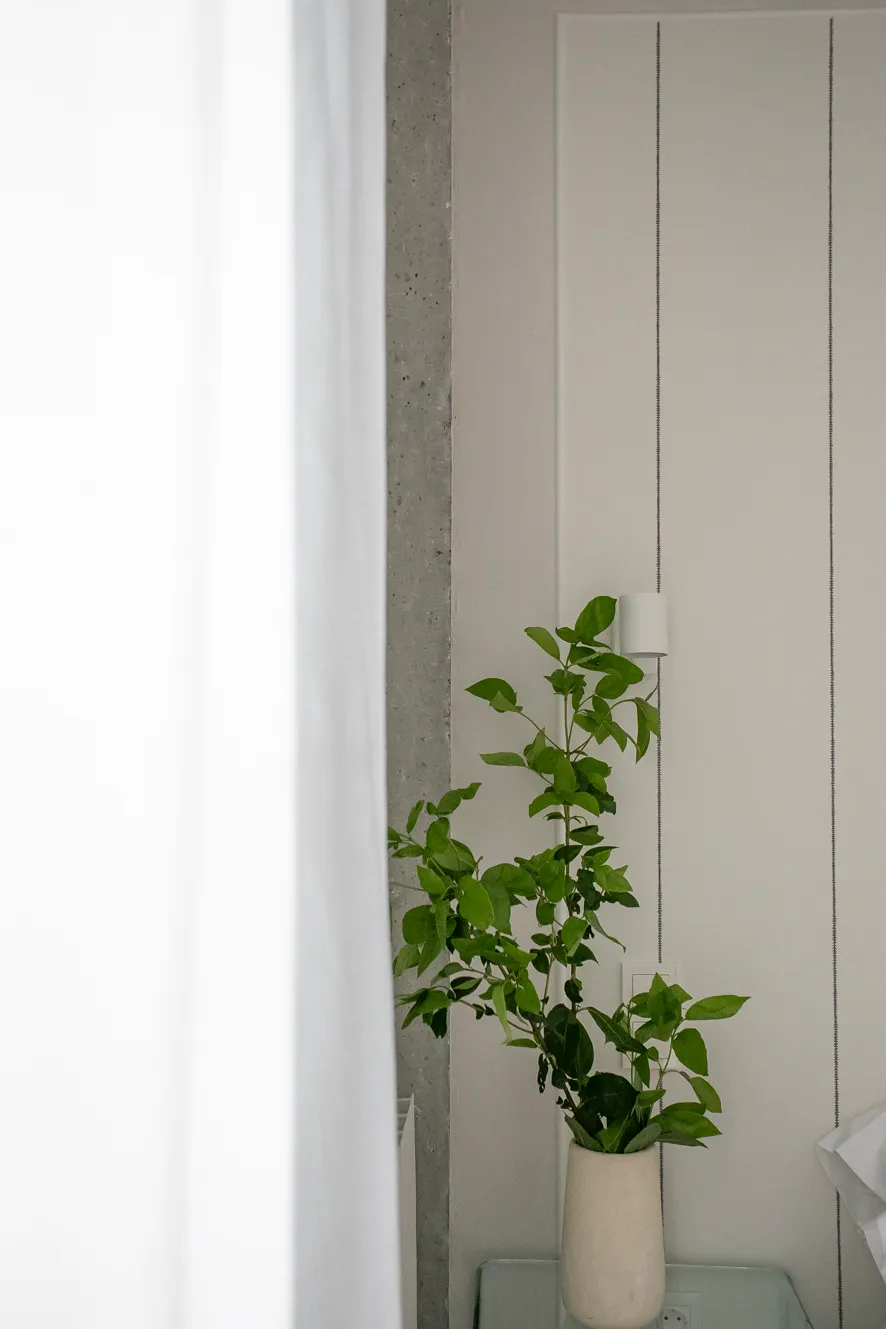 Rincón de descanso en el dormitorio matrimonio con iluminación suave y textiles naturales